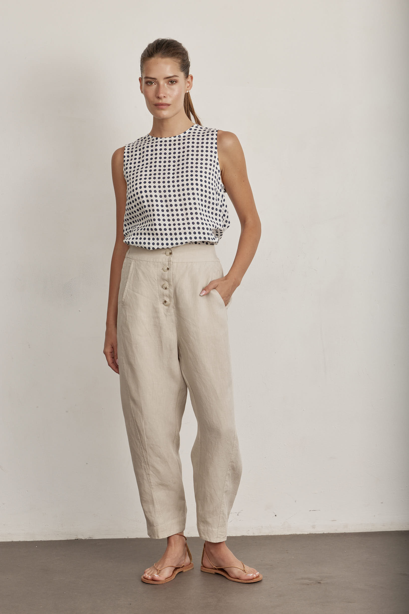White sleeveless top with navy polka dots