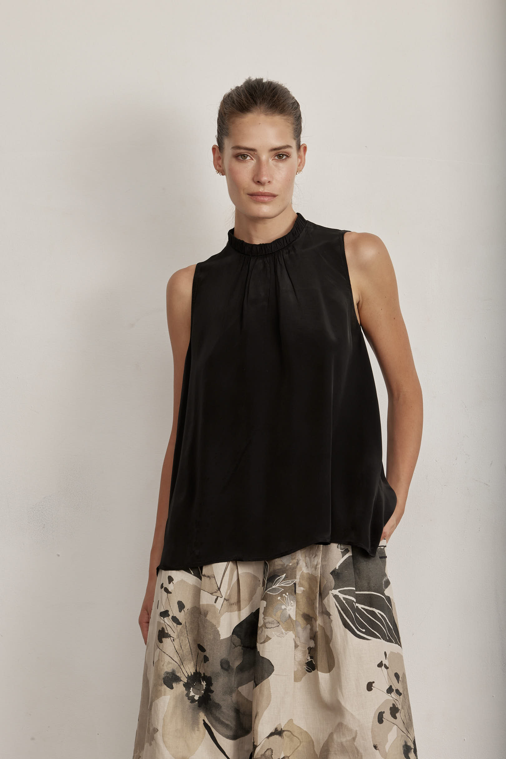 Black sleeveless top with ruffled center panel